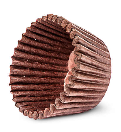 Stack of brown paper cups for baking muffins on the side isolated on white backgroundの写真素材