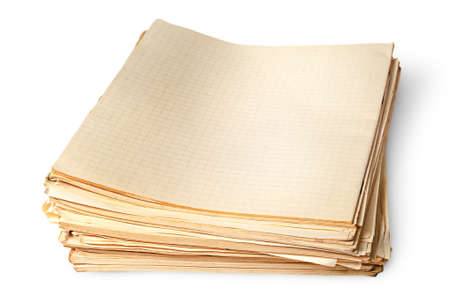 Stack of old yellowed sheets of school notebooks top view isolated on white backgroundの写真素材