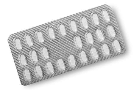 Tablets in packing foil isolated on white backgroundの写真素材