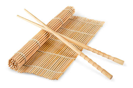 Sushi mat partially deployed and chopsticks isolated on a white backgroundの写真素材