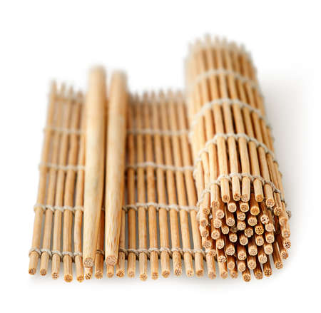 Sushi mat partially deployed and chopsticks perspective isolated on a white backgroundの写真素材