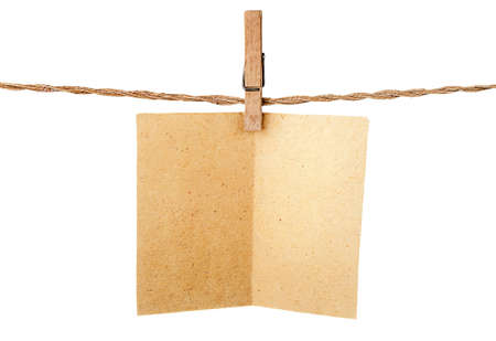 Piece old sheet of paper on clothespins isolated on white backgroundの写真素材