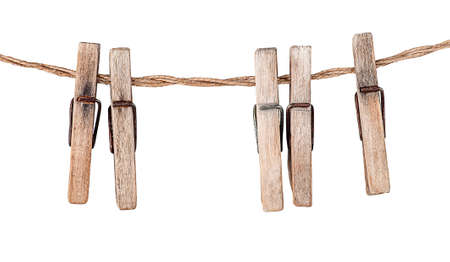 Five old clothespins on rope isolated on white backgroundの写真素材