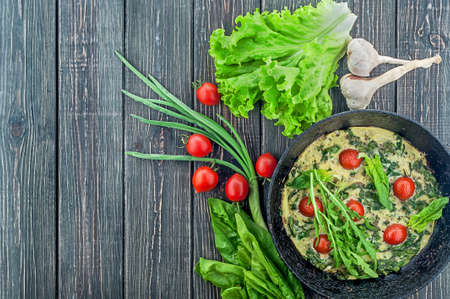 Fritatta with tomatoes and ingredientsの写真素材