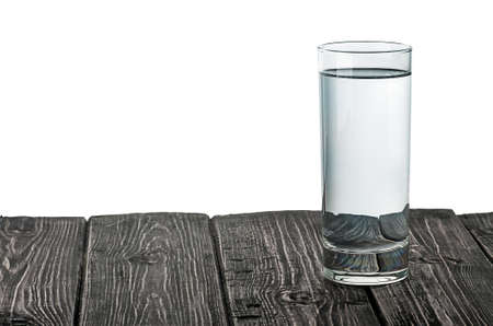 Single glass of water on wooden tableの写真素材