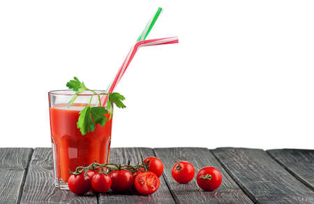 Glass of tomato juice with cocktail stickの写真素材