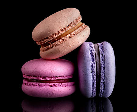 Heap of colorful macaroons on black backgroundの写真素材