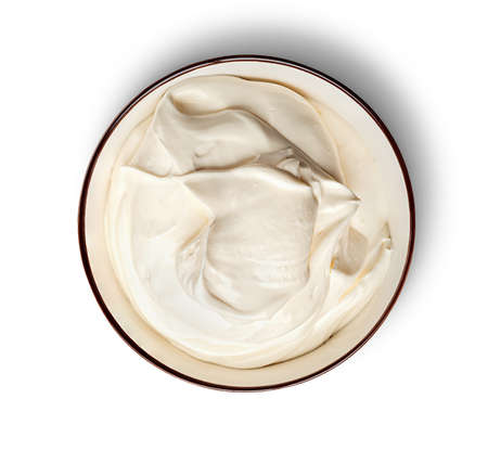 Sour cream in bowl top view isolated on white backgroundの写真素材