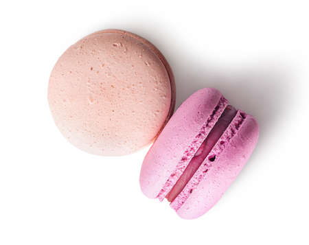 Two macaroon beige pink top view on white backgroundの写真素材
