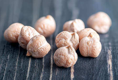 Closeup several chickpeas on a wooden tableの写真素材