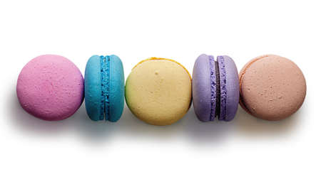 Five multicolored macaroon in row on white backgroundの写真素材