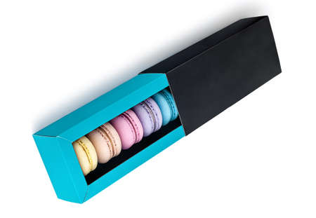 Macaroons in gift box top view on white backgroundの写真素材