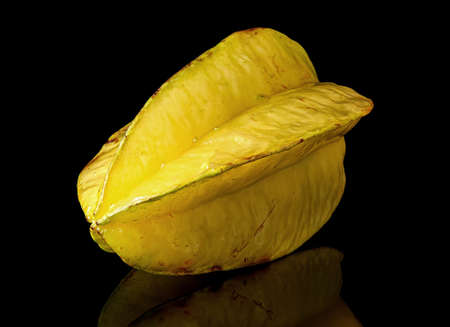 Ripe yellow carom rotated with reflection on blackの写真素材