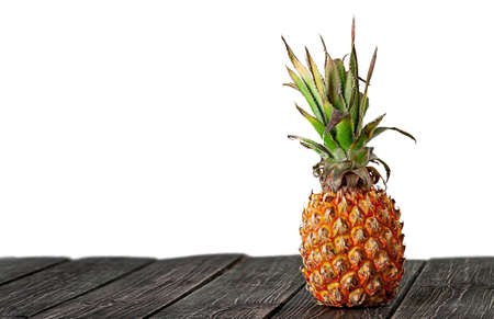 Pineapple stands on wooden boards isolated on white backgroundの写真素材