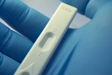 Gloved Hand Holding HIV Rapid Testの写真素材