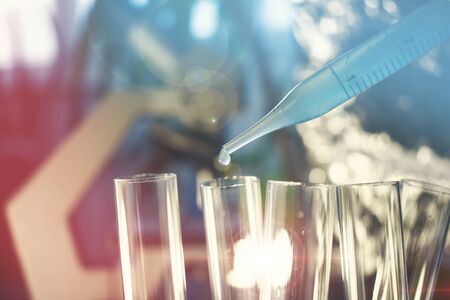 Pipette with fluid and test tubes for cancer immunotherapy research cancer study and gene therapyの写真素材
