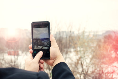 man taking a picture with smartphone picture in picture effect business man holding phone