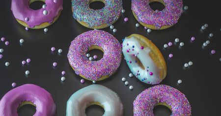 colorful donuts assorted donuts with chocolate frosted, pink glazed and sprinkles donutsの写真素材