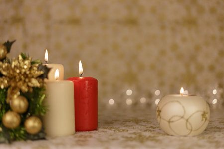 Greeting Christmas card with burning candles and ornamentsの写真素材