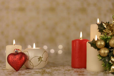 Greeting Christmas card with burning candles and ornamentsの写真素材