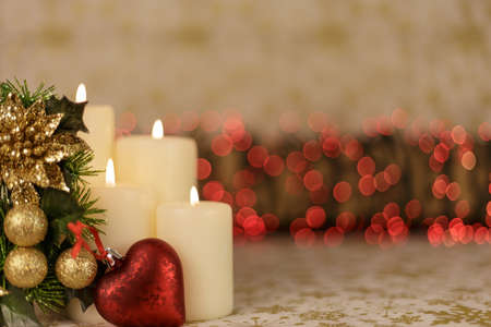 Greeting Christmas card with burning candles and ornamentsの写真素材