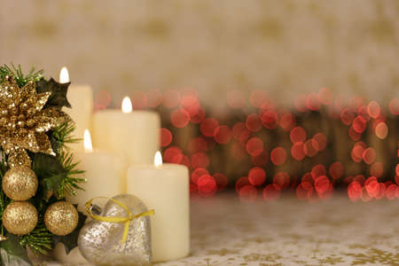 Greeting Christmas card with burning candles and ornamentsの写真素材