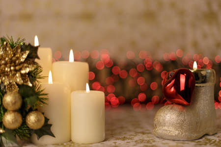 Greeting Christmas card with burning candles and ornamentsの写真素材