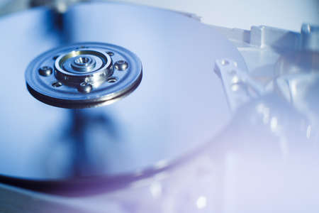 Opened Hard Disk Drive photographed with soft focus and soft flare with blue darktonesの写真素材