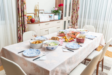 Celebration table with appetizers, salads, main and side dishes ready for the guestsの写真素材