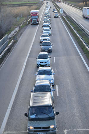 Sofia, Bulgaria - Apr 15 2020: Long queue of cars has lined up at Hemus motorway checkpoint waiting to leave Sofia.のeditorial素材