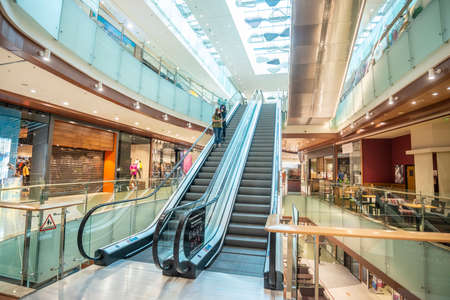 Sofia, Bulgaria - May 18 2020: Interior of a shopping mall with people using the escalators in protective masksのeditorial素材