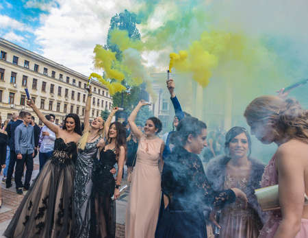 Sofia, Bulgaria - May 25 2019: Graduates gathering in front of National Theater to celebrate their graduation with colored smoke sticks.のeditorial素材