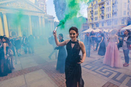 Sofia, Bulgaria - May 25 2019: Graduates gathering in front of National Theater to celebrate their graduation with colored smoke sticks.のeditorial素材