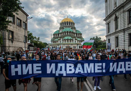 Sofia, Bulgaria - Jul 14 2020: People carrying We are coming banner in front of St. Alexander Nevski Cathedral during the anti-government protests in the capitalのeditorial素材