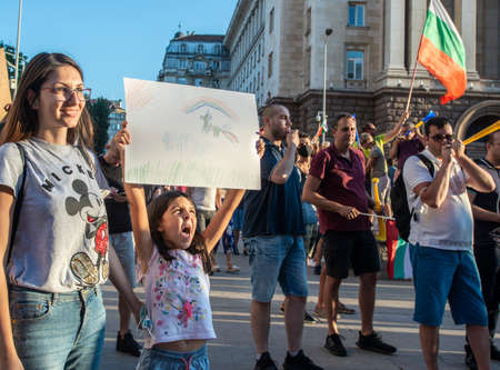 Sofia, Bulgaria - Jul 29 2020: A little girl carrying a painting with a unicorn while taking part in nationwide protests against the governmentのeditorial素材