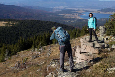 Rhodope mountains, Bulgaria - Nov 1 2020: A woman is being photographed for social media after climbing Batashki snezhnik mountain topのeditorial素材