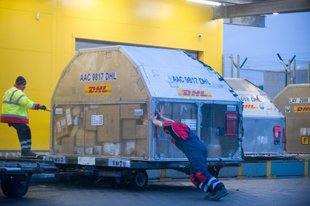 Sofia, Bulgaria - Jan 4 2021: Two people dragging and pushing a container with Covid-19 vaccines at...