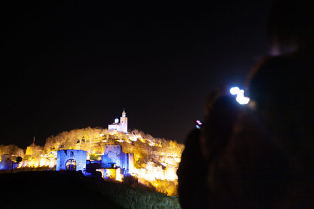 Tsarevtes hill illuminated in different colors during Sound and Light show on a winter nightのeditorial素材