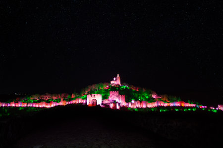Tsarevtes hill illuminated in different colors during Sound and Light show on a winter nightのeditorial素材