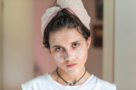 A teen girl after bath with cosmetic maskの写真素材