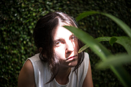 Young girl hiding behind plants