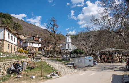 Leshten, Bulgaria - Feb 28 2021: Overview towards the main square in Leshten with St. Paraskeva church, old school, souveninr shop and the bus stopのeditorial素材
