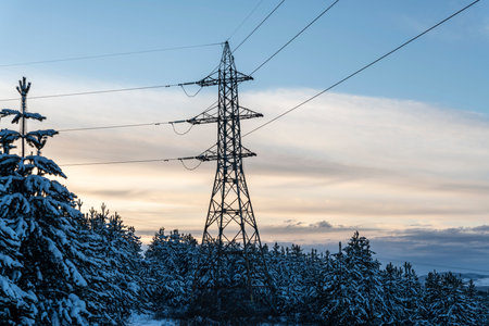 An electric pillar in a cold snowy mountain at sunset