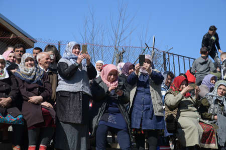 Ribnovo, Bulgaria - Apr 11 2021: Women taking photos of the circumvetion celebration with their smartphonesのeditorial素材