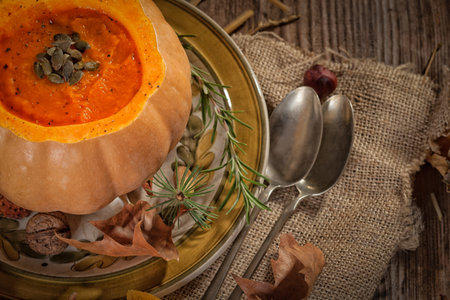 Pumpkin soup on rustic tableの写真素材