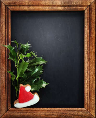 Christmas holly on wooden frameの写真素材
