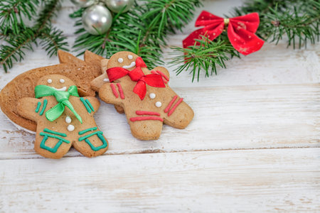 Christmas gingerbread cookie couple on white wooden board with copy space
