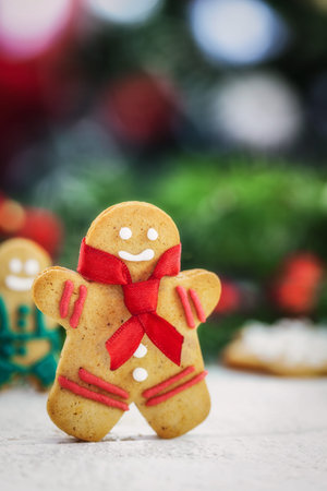 Christmas gingerbread men cookies on white wooden board with copy space