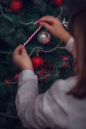 Close up of young girl decorating Christmas treeの写真素材
