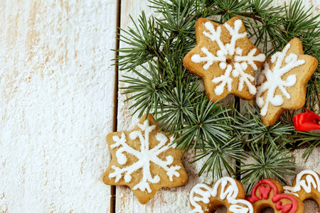 Christmas gingerbread cookies on white wooden backgroundの写真素材